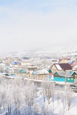 Top view of the winter village in the fog and frostの写真素材