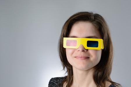 A young Woman black dress in 3d glassesの写真素材