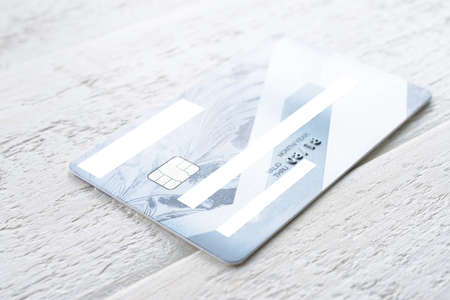 Credit card lying on a white wooden tableの写真素材