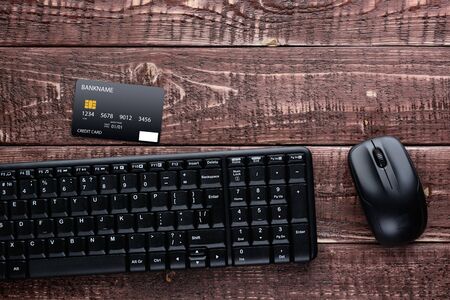 Top view of a brown wooden table with accessories for online shopping and paymentの写真素材