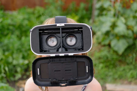 A little child playing a virtual reality glasses