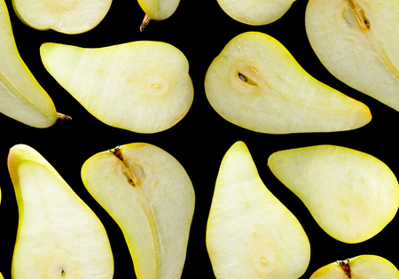 Slices of green pears on a black background