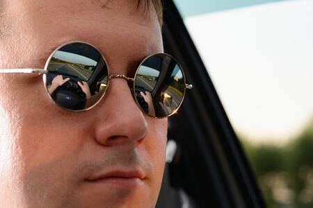 Reflection suburban road in sun glasses menの写真素材