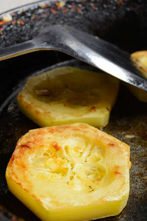 Fried courgette on the old pan closeupの写真素材