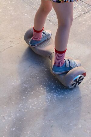 Girl on a hoverboard in the amusement parkの写真素材