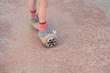 Girl on a hoverboard in the amusement parkの写真素材