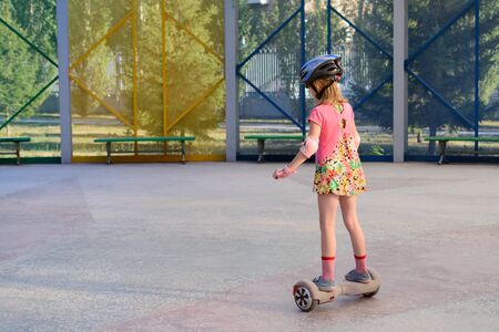 Girl riding on the hoverboard in the parkの写真素材