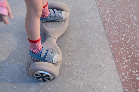 Girl on a hoverboard in the amusement parkの写真素材