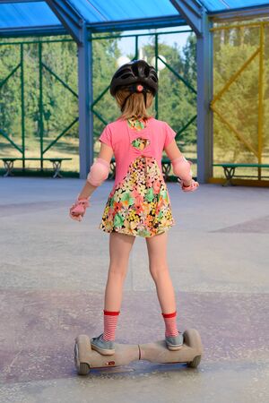 Girl riding on the hoverboard in the parkの写真素材
