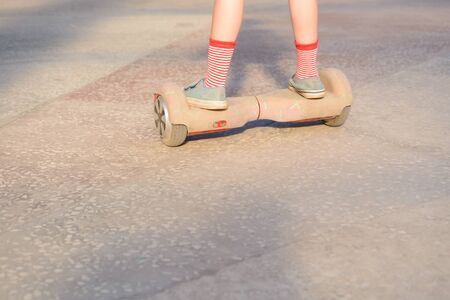Girl on a hoverboard in the amusement parkの写真素材