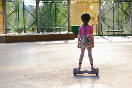 Girl riding on the hoverboard in the parkの写真素材