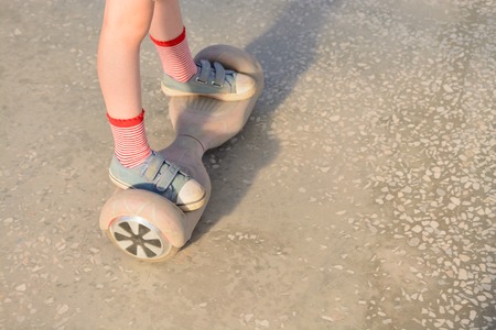 Girl on a hoverboard in the amusement parkの写真素材