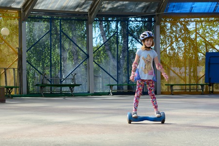 Girl riding on the hoverboard in the parkの写真素材