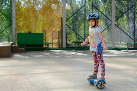 Girl riding on the hoverboard in the parkの写真素材