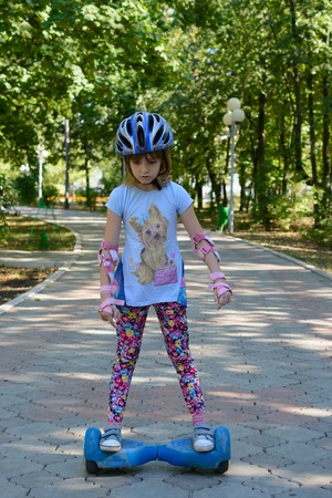 Girl riding on the hoverboard in the parkの写真素材