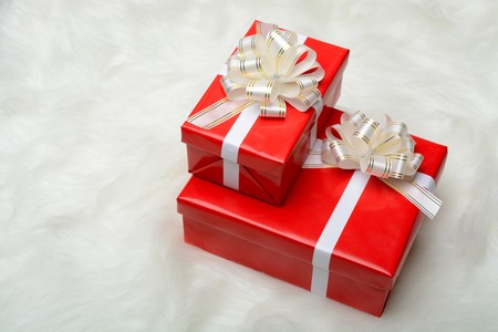 Two red boxes with gifts on a white carpet from furの写真素材