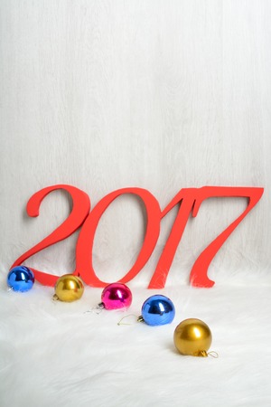 Number 2017 and Christmas decorations on a white carpet from fur