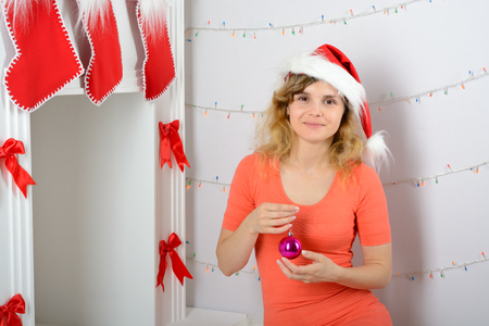 The girl in the orange dress is decorated with a fireplace for Christmasの写真素材