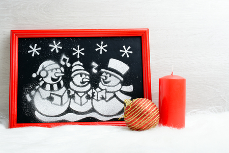 Drawn artificial snow snowmen in red boxの写真素材