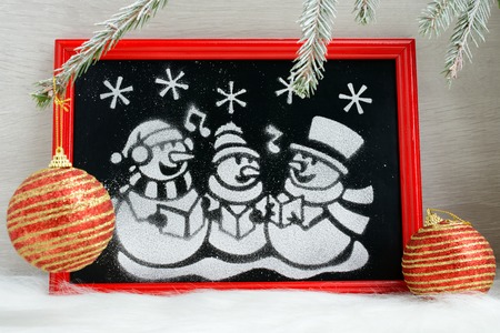 Drawn artificial snow snowmen in red boxの写真素材
