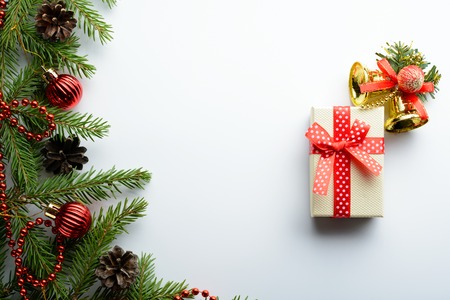 Spruce branches, red beads and gift box on a white backgroundの写真素材
