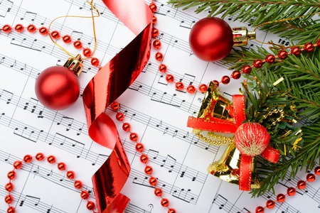 ChristmChristmas decorations and fir branch lying on notes sheetas decorations lying on notes sheetの写真素材