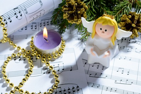 Christmas decorations and fir branch lying on notes sheetの写真素材