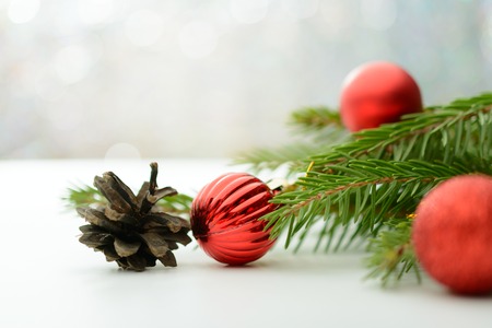 Christmas decoration red ball, pine cone and branchの写真素材