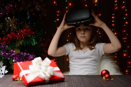 The girl received a Christmas present of virtual reality glassesの写真素材