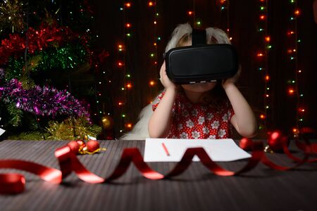 The girl received a Christmas present of virtual reality glassesの写真素材