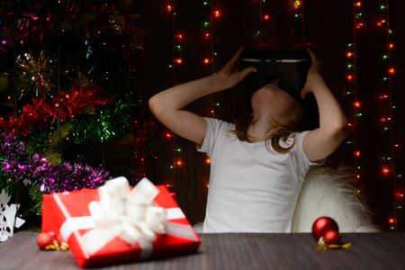 The girl received a Christmas present of virtual reality glassesの写真素材