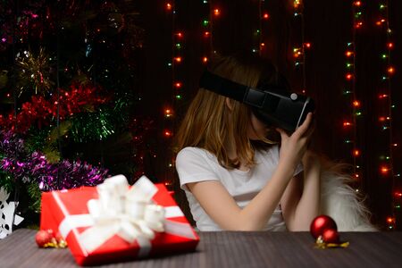 The girl received a Christmas present of virtual reality glassesの写真素材