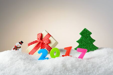 Christmas decoration snowman, Christmas tree, gift box and 2017 in the snowの写真素材