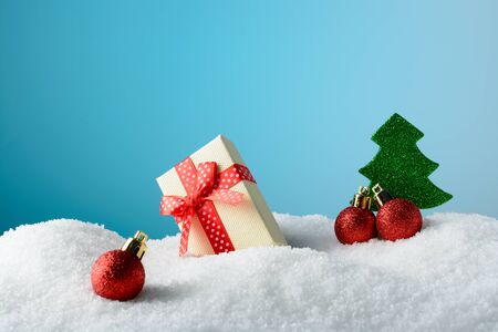 Christmas decorations in the snow on a blue backgroundの写真素材