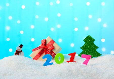 Christmas decoration snowman, Christmas tree, gift box and 2017 in the snowの写真素材