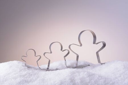 Metal molds for Christmas cookies in the snowの写真素材