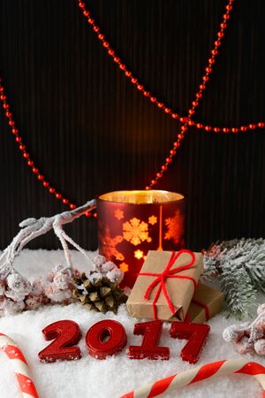 Box with a gift and New Year decorations on white snowの写真素材