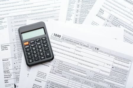 The tax return form with a calculator on the table