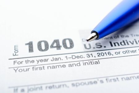 The tax return form with a pen