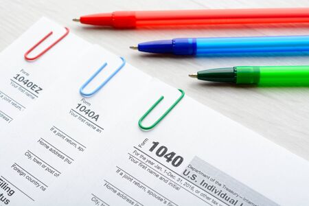 The tax return form with pen and paper clips