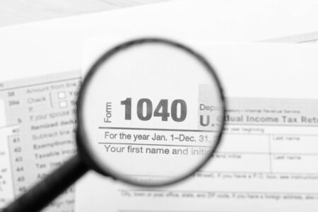 Tax declaration forms through a magnifying glassの写真素材