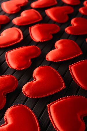 Red hearts made of cloth on a bamboo leafの写真素材