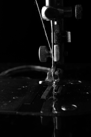 Retro elements of the sewing machine on a black background closeup