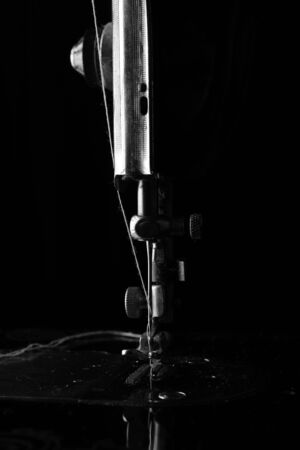 Retro elements of the sewing machine on a black background closeupの写真素材