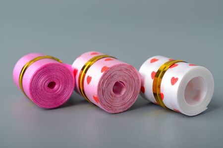 Decorative ribbon for decorating a box with a gift on a gray backgroundの写真素材