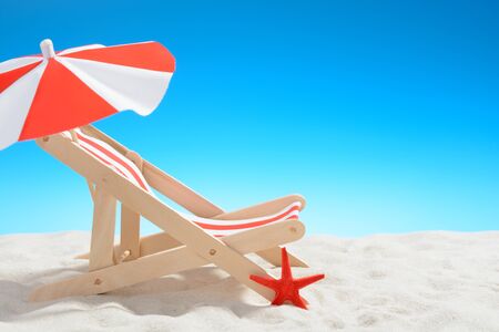 Deckchair at the beach on background of blue skyの写真素材