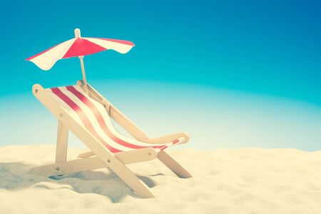 Deckchair at the beach on background of blue skyの写真素材