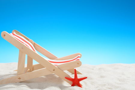 Deckchair at the beach on background of blue skyの写真素材