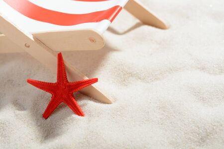 Red starfish near a lounger on the beach: closeupの写真素材