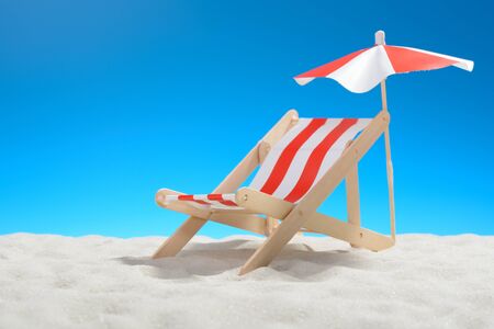Deckchair on the beach on background of blue skyの写真素材